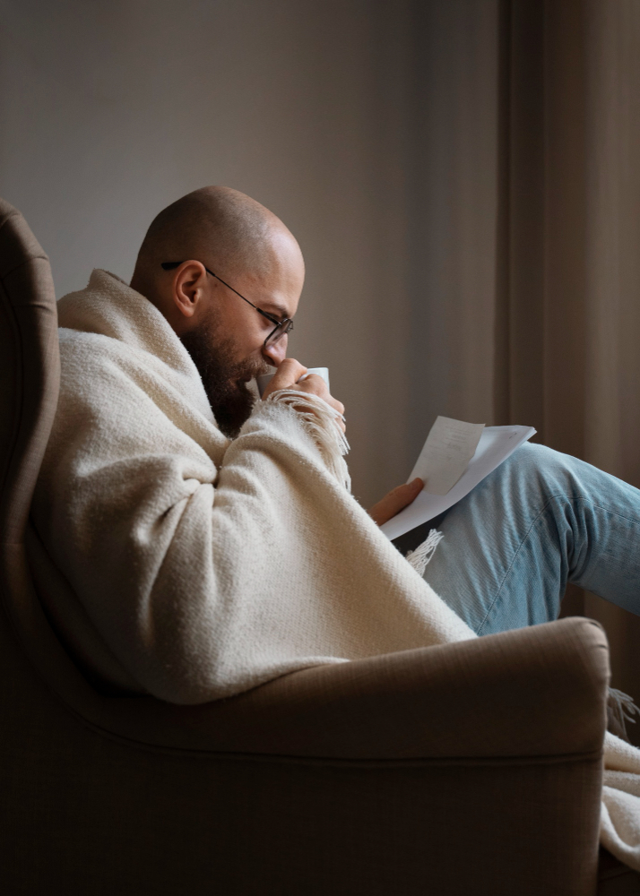 Man drinking hot beverage during energy crisis