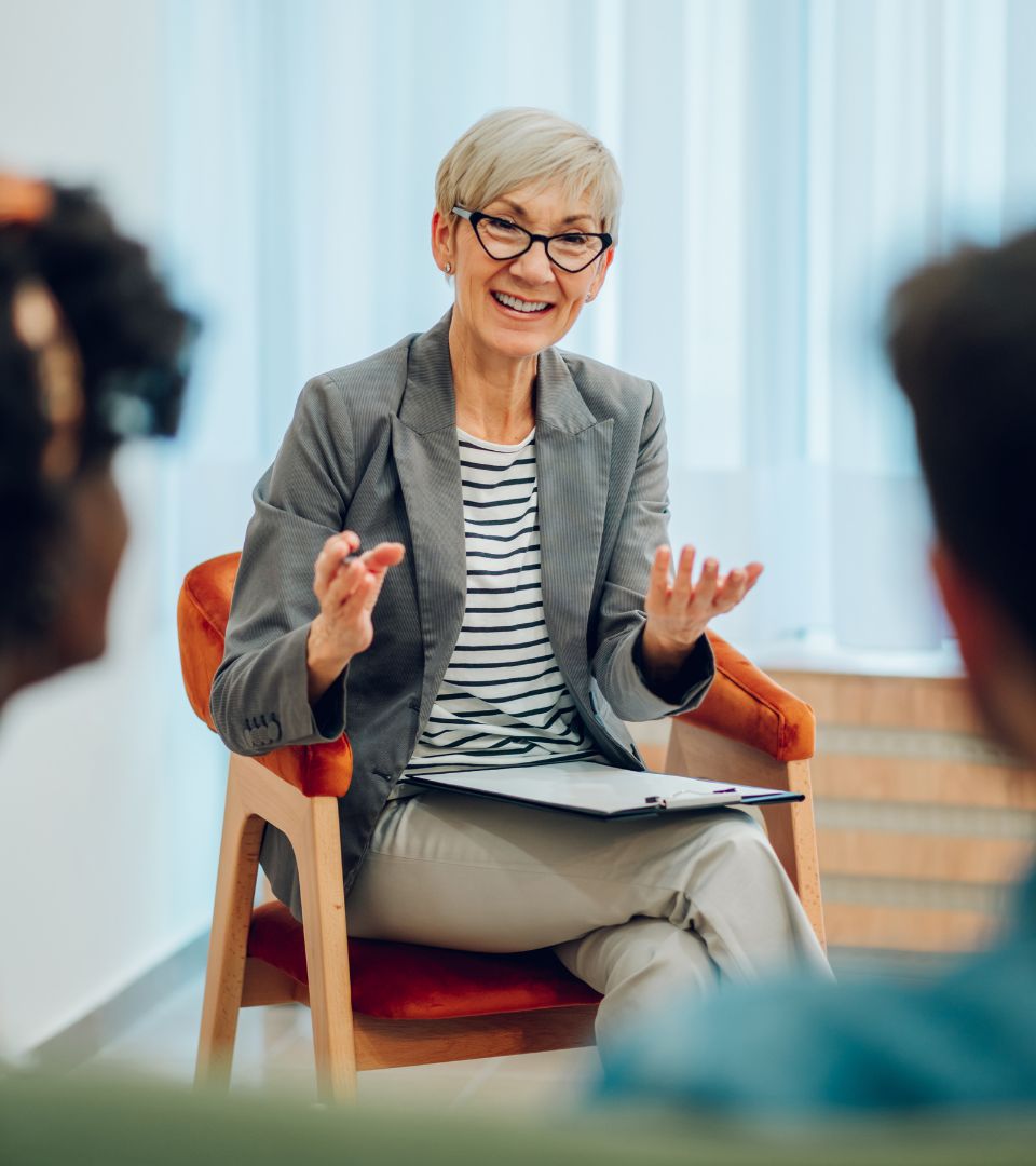 Young girl talking to therapist side view<br />
