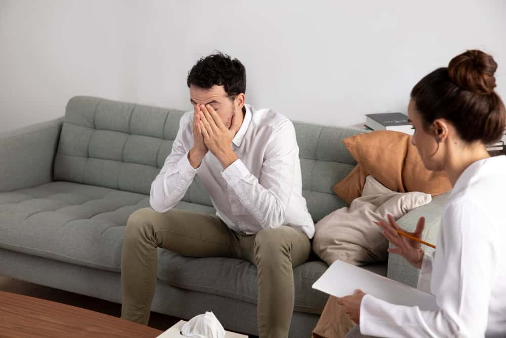 Young person with depresion talking to specialist