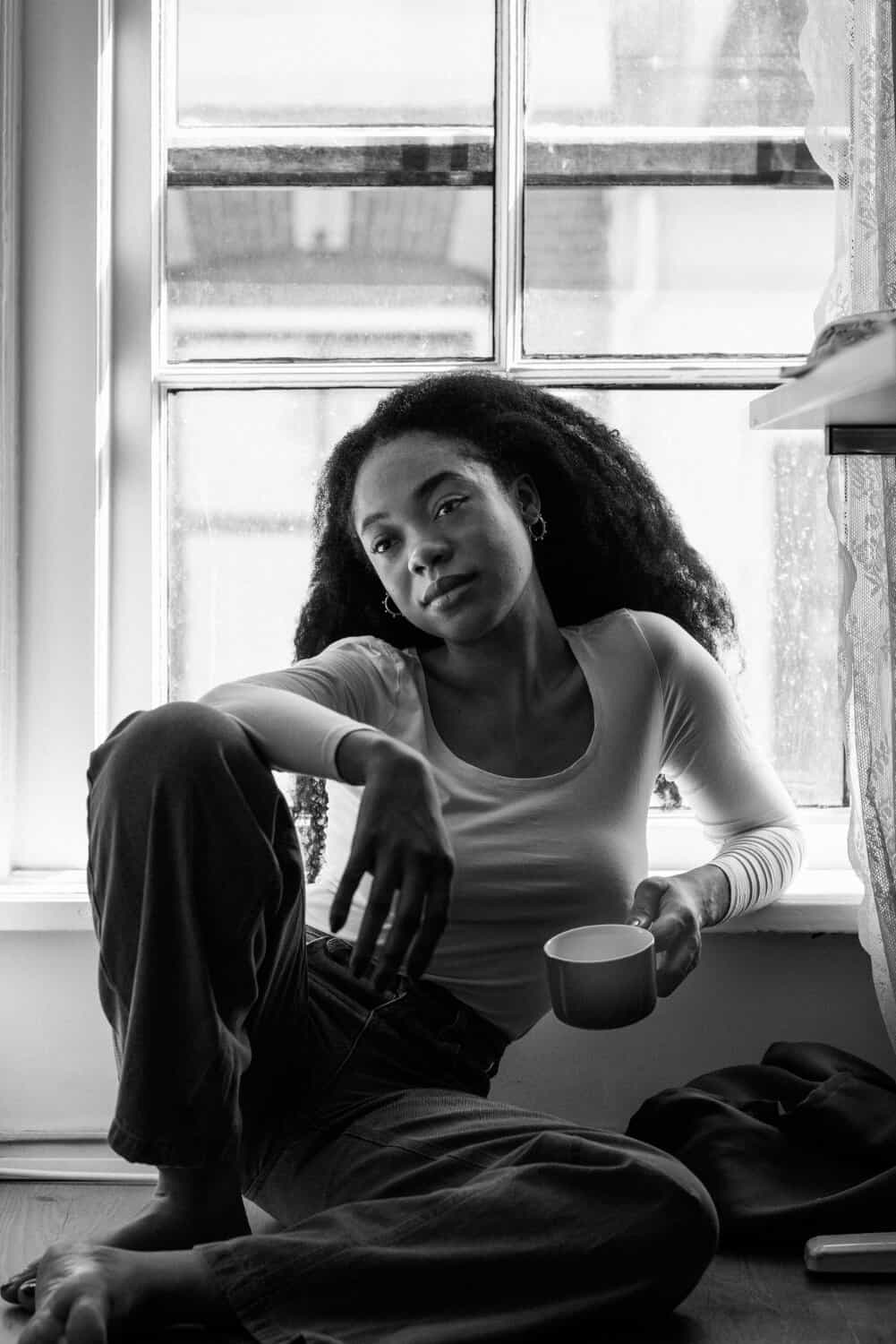 Front view woman holding cup at home
