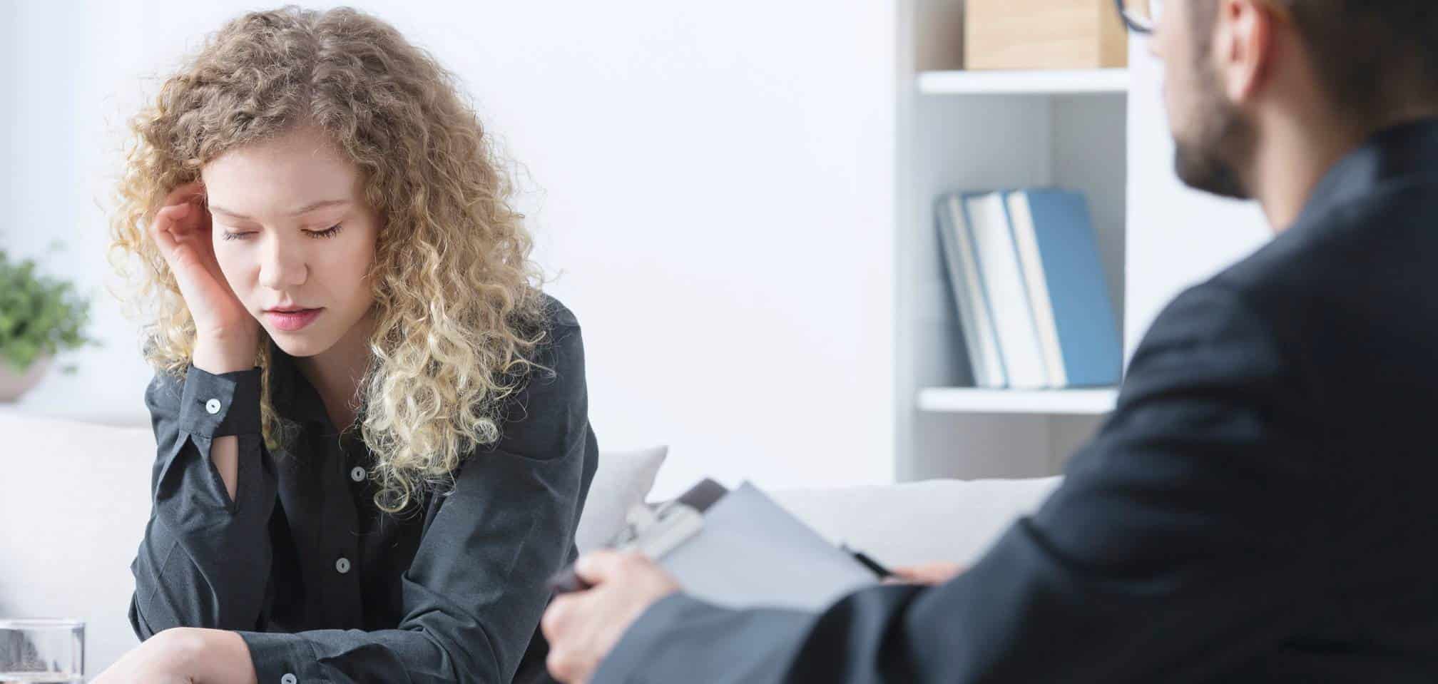 Therapist listening as a woman discusses her experiences during ADHD treatment in Massachusetts.