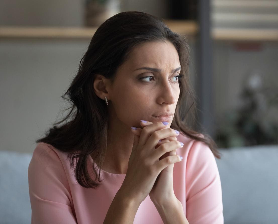 Woman deep in thought during a quiet moment.