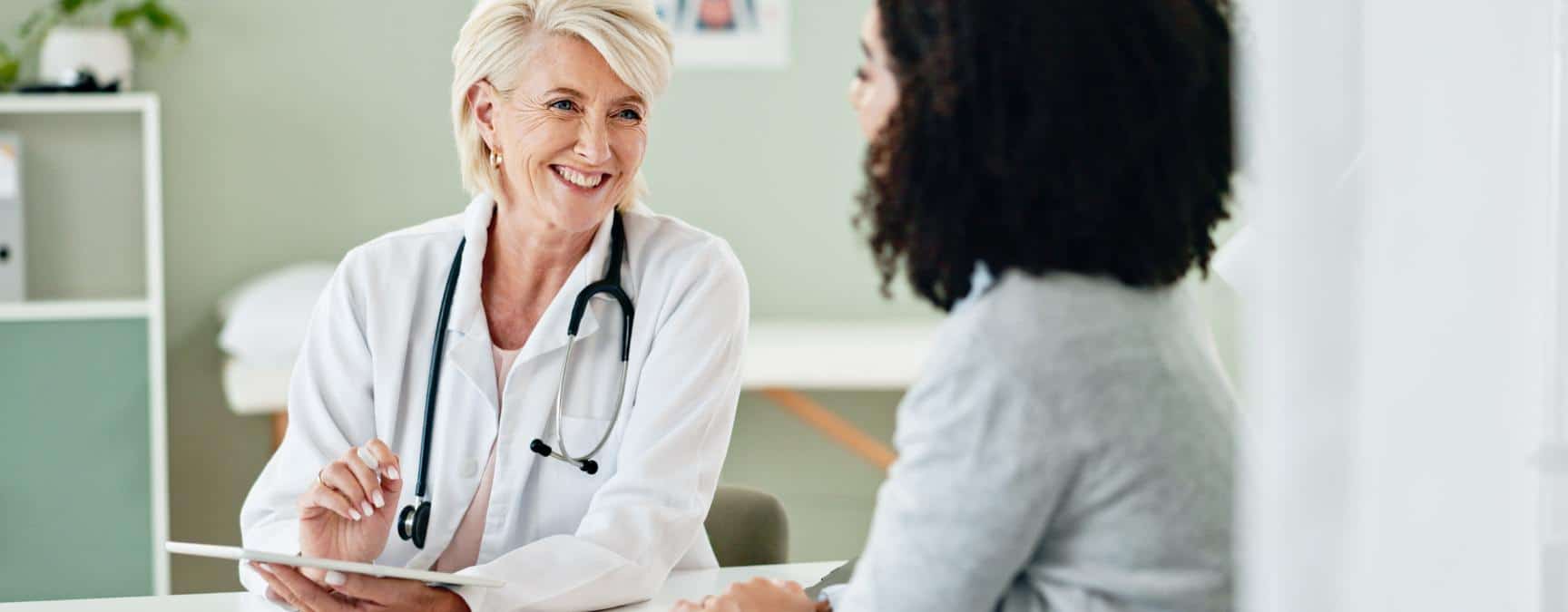 Doctor warmly speaking with a client during anxiety treatment in Massachusetts.