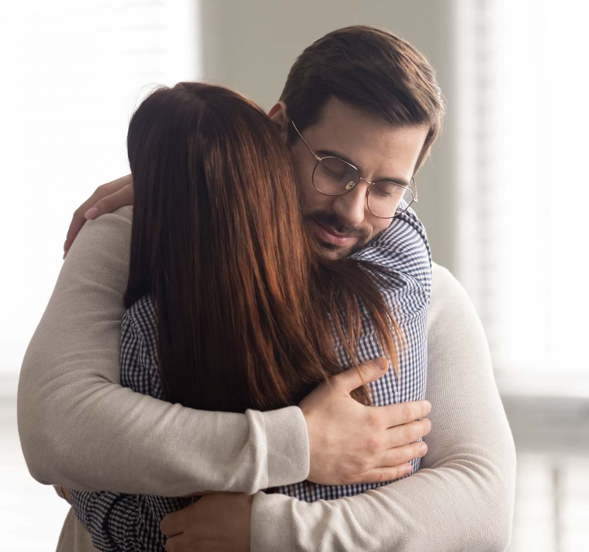 Man finding comfort with a loved one during family therapy in Massachusetts.
