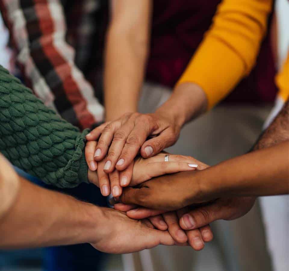 Clients encouraging one another in group therapy in Massachusetts.