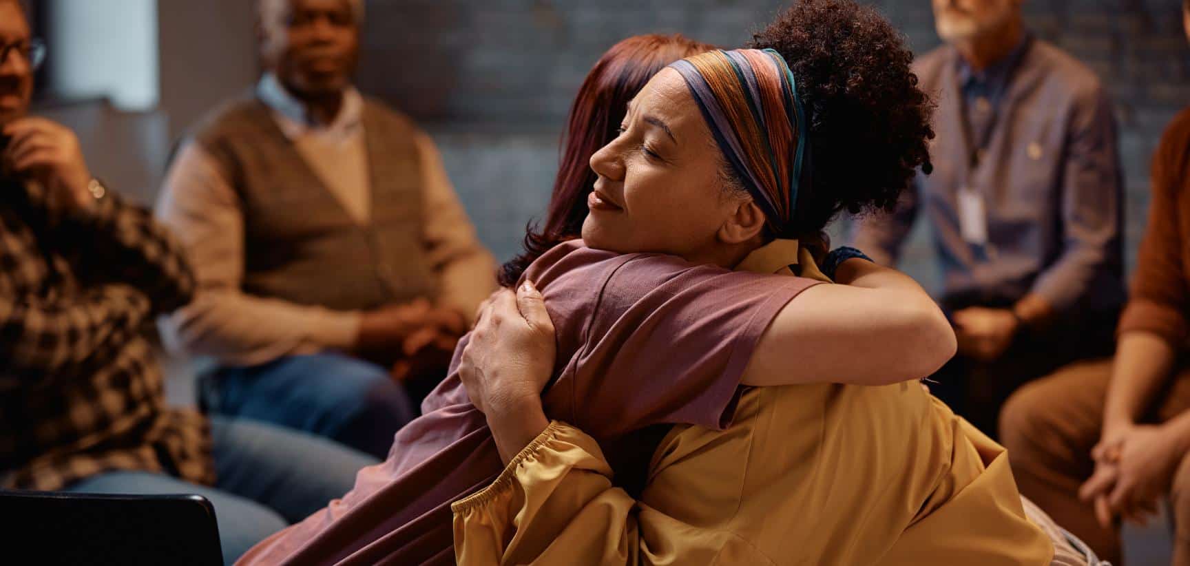 Connection and support between two women in PTSD treatment in Massachusetts.