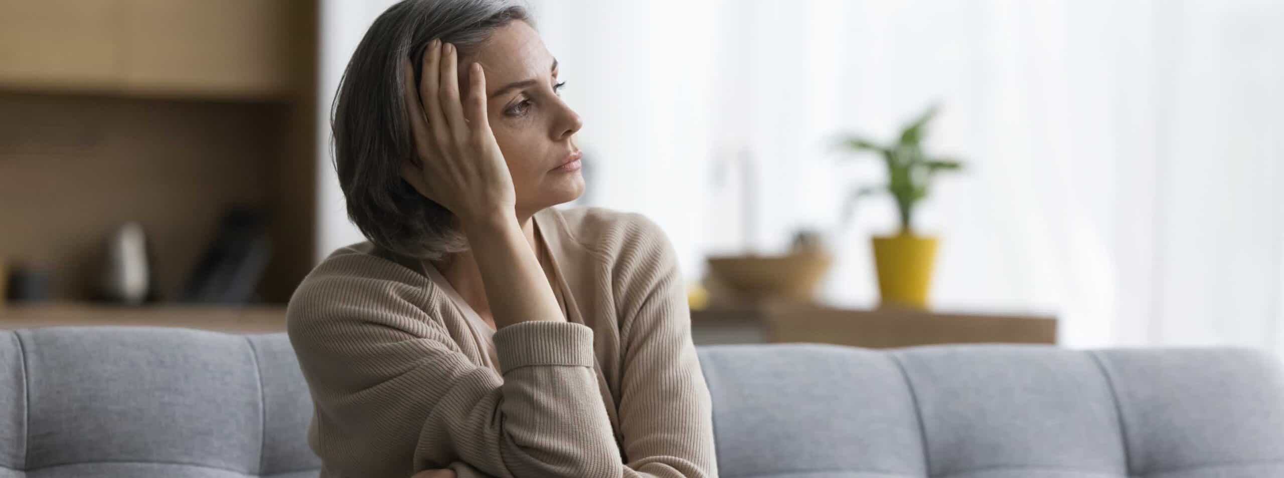Woman taking a quiet moment to reflect at home.