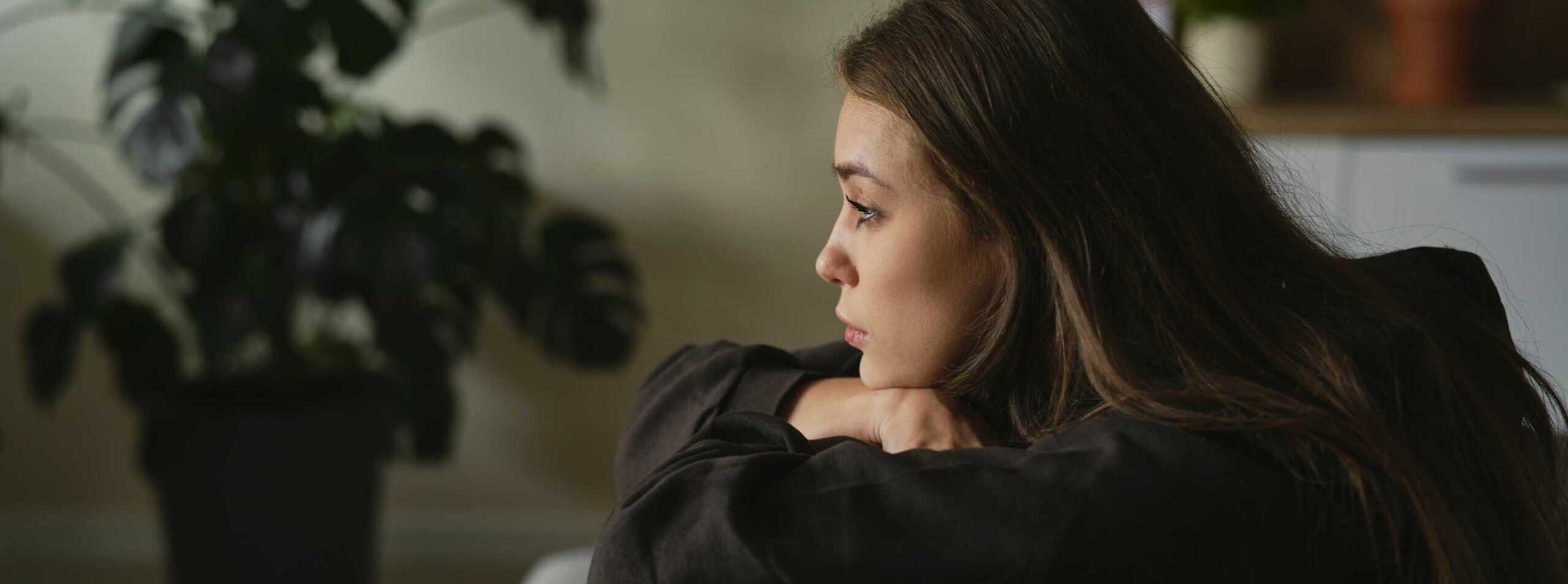 Woman taking a quiet moment on the couch.