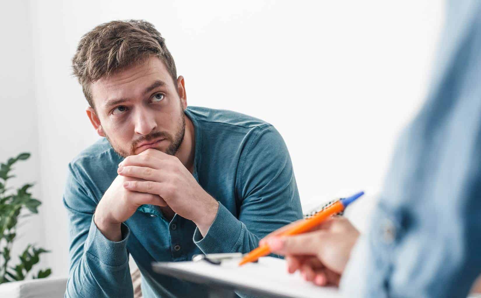 Man focused on a therapy session for bipolar disorder treatment in Massachusetts.