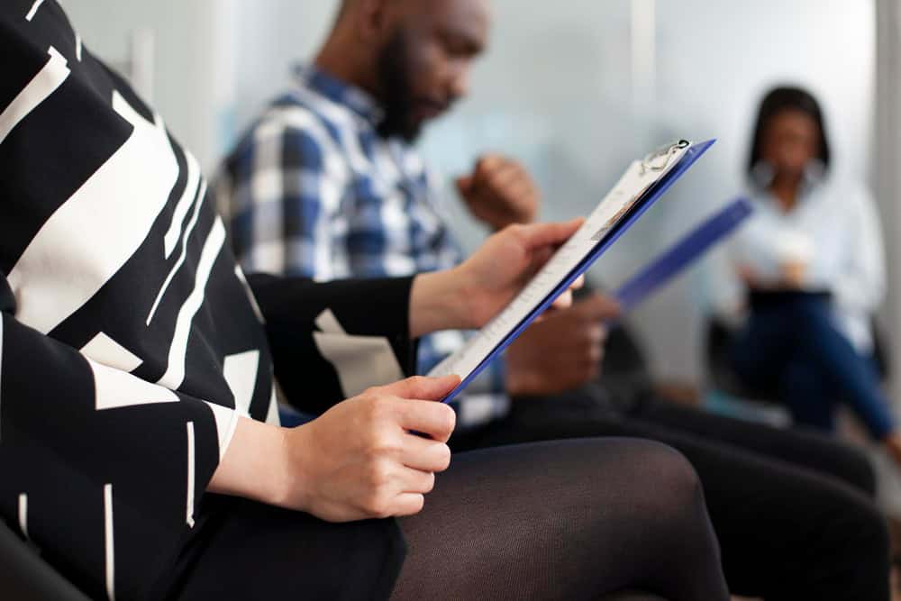 Woman holding a notebook while preparing for trauma therapy for PTSD in Massachusetts at Brook Behavioral Health.
