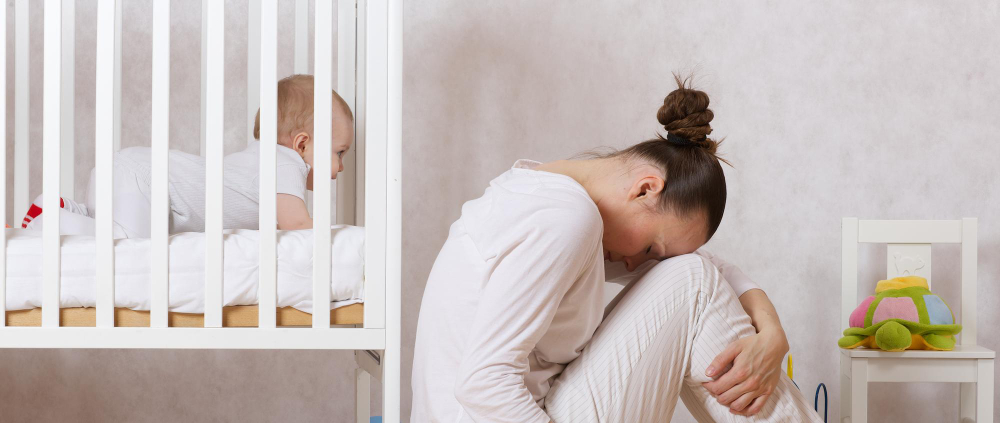 Young mother experiencing postpartum depression and possible signs of postpartum depression.