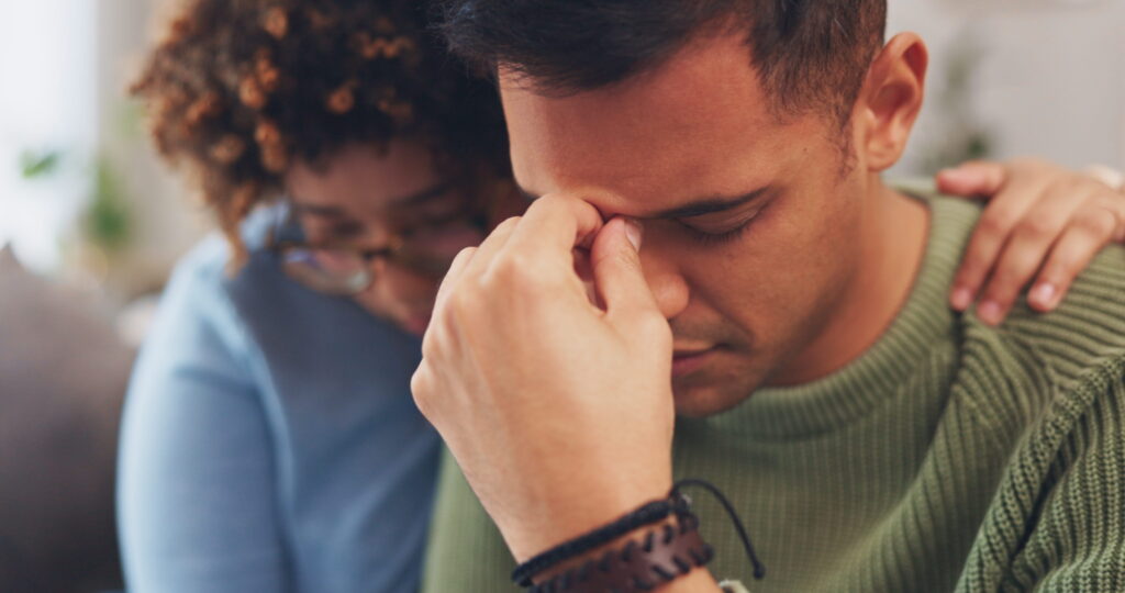 A woman encourages her spouse after learning how to encourage someone to go to therapy.